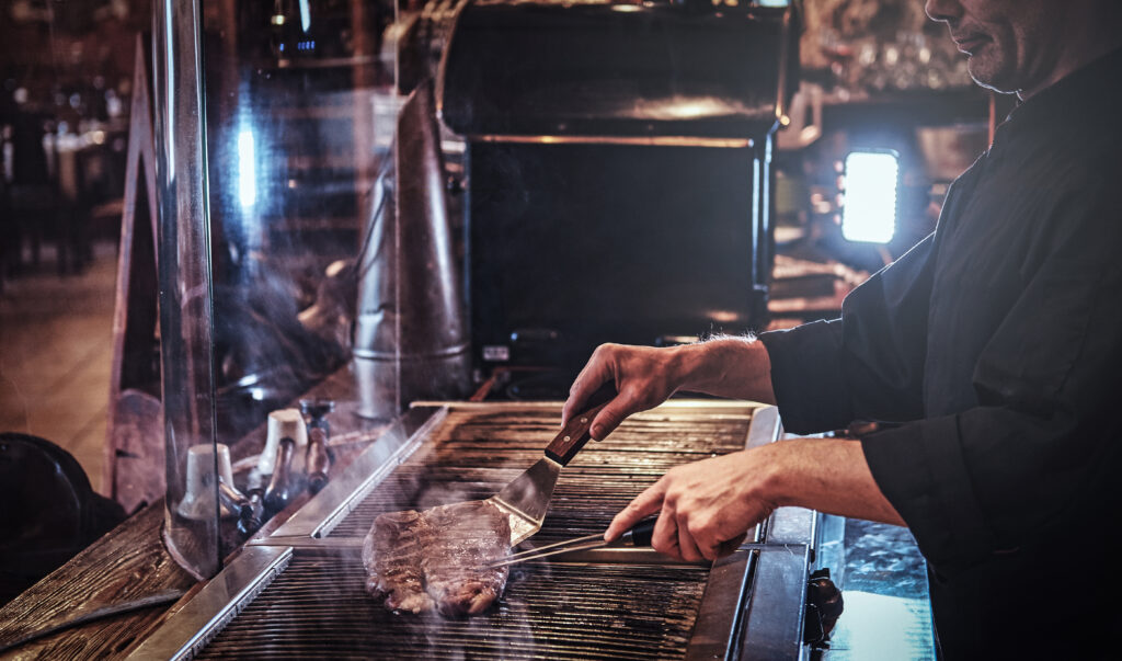 professional chef cooking on commercial grill