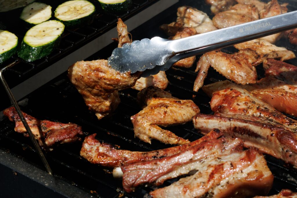 grilled food getting tossed to cook evenly